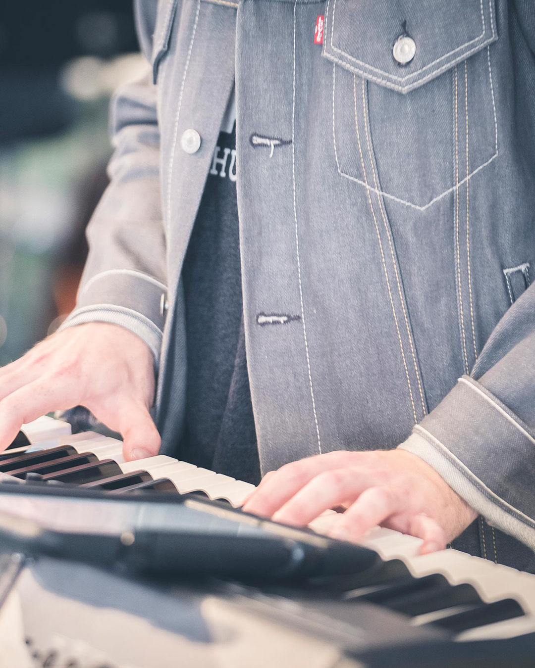 Keyboardist playing during a weekend worship service at Pearce Church in Rochester, NY